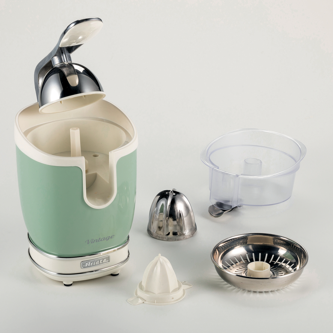 A pastel green Ariete Vintage juicer with disassembled parts, including a metal reamer and a clear plastic container.