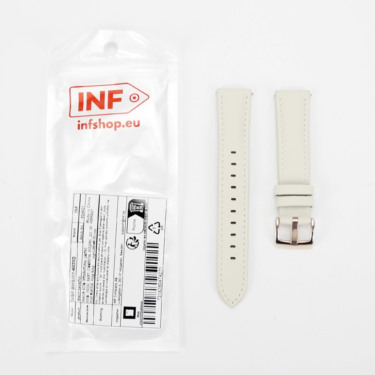 Ein weißes Uhrenarmband mit einer rosé goldenen Schließe liegt neben seiner Markenverpackung.