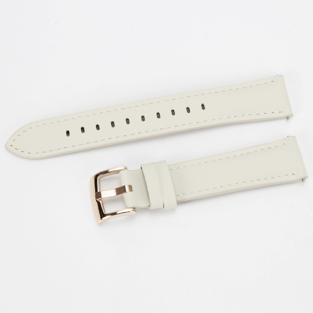 Ein beiges Lederuhrarmband mit roségoldener Schließe vor weißem Hintergrund.