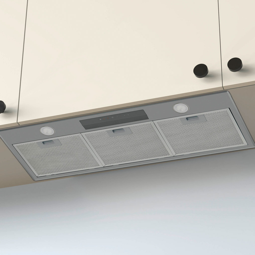 Cappa aspirante da incasso con filtri in acciaio inox e luci LED sotto pensili chiari.