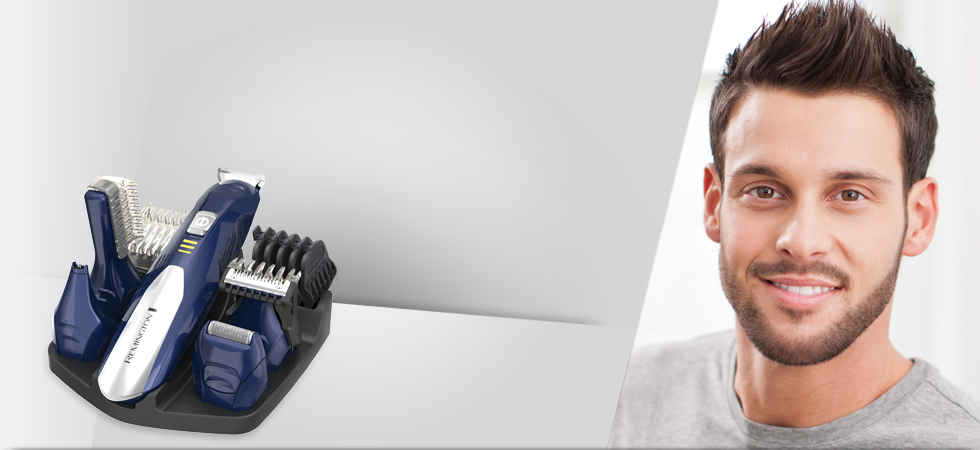 A Remington grooming kit with accessories in a stand next to a smiling man.
