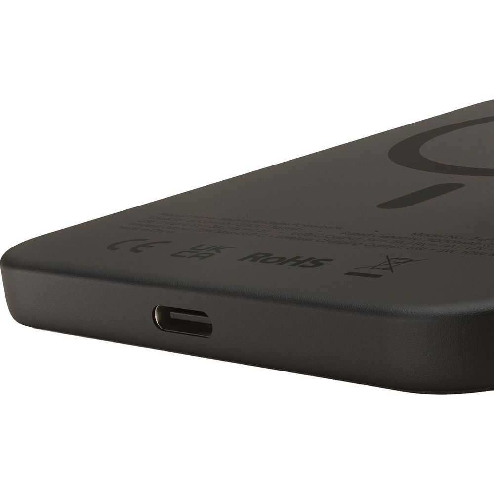 A close-up of a black power bank, showing its USB-C port and regulatory certification symbols.