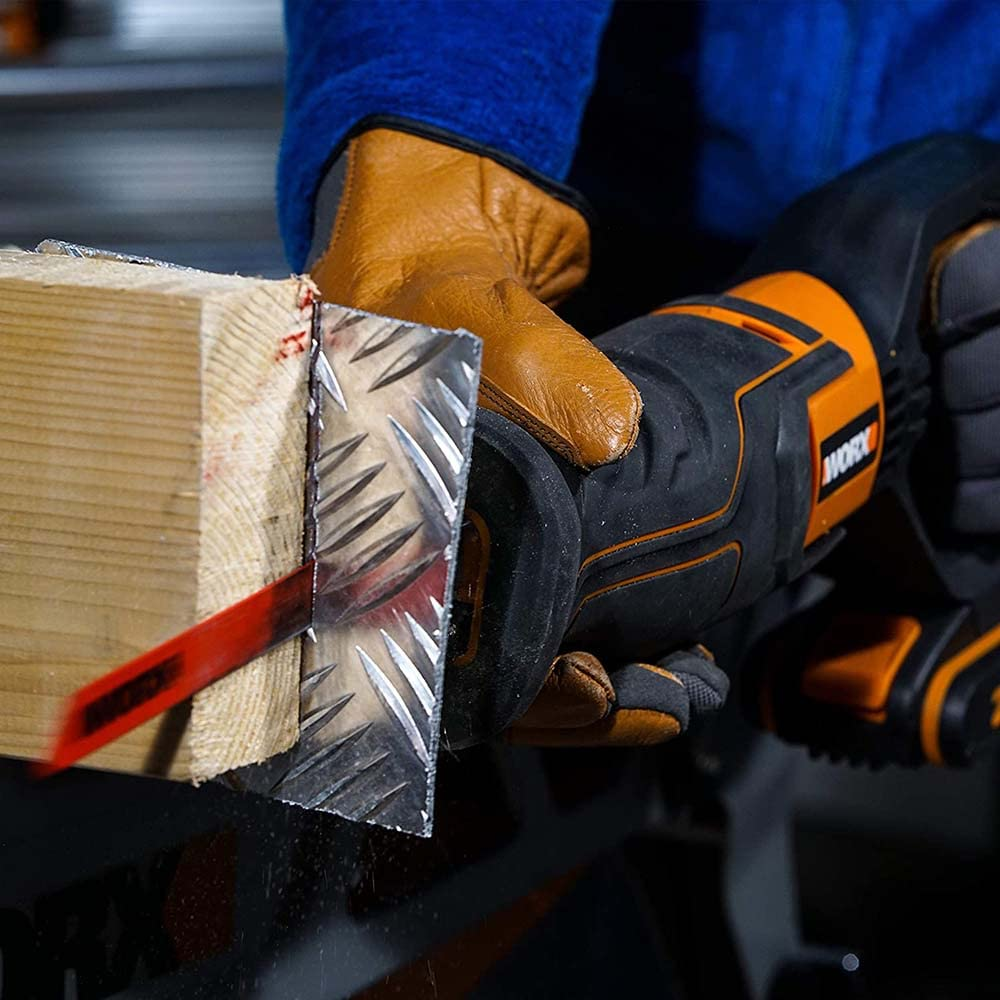Person schneidet mit einer elektrischen Säge Holz und Metallplatte.