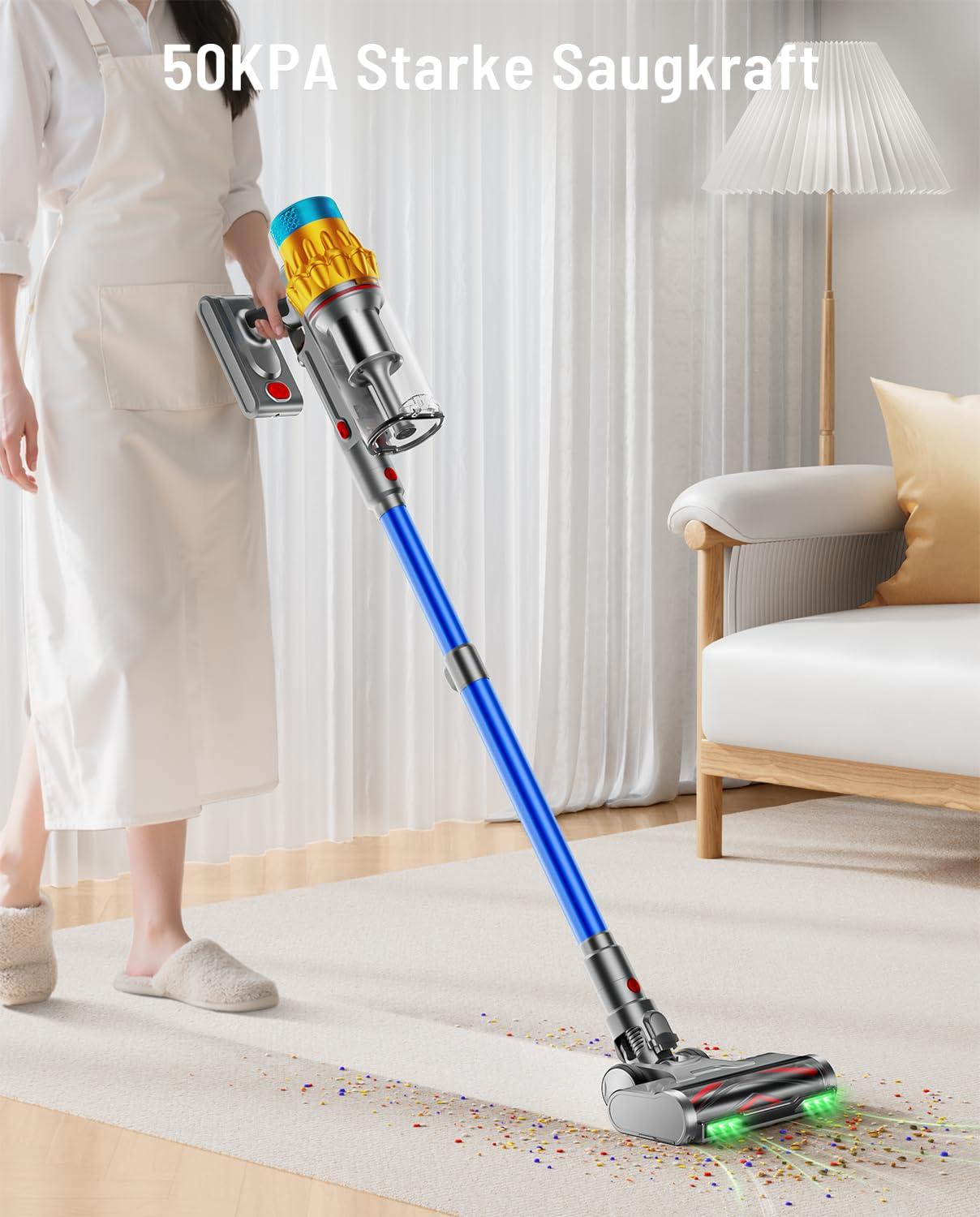 Una donna con grembiule bianco aspira detriti colorati da un tappeto con un aspirapolvere senza fili.