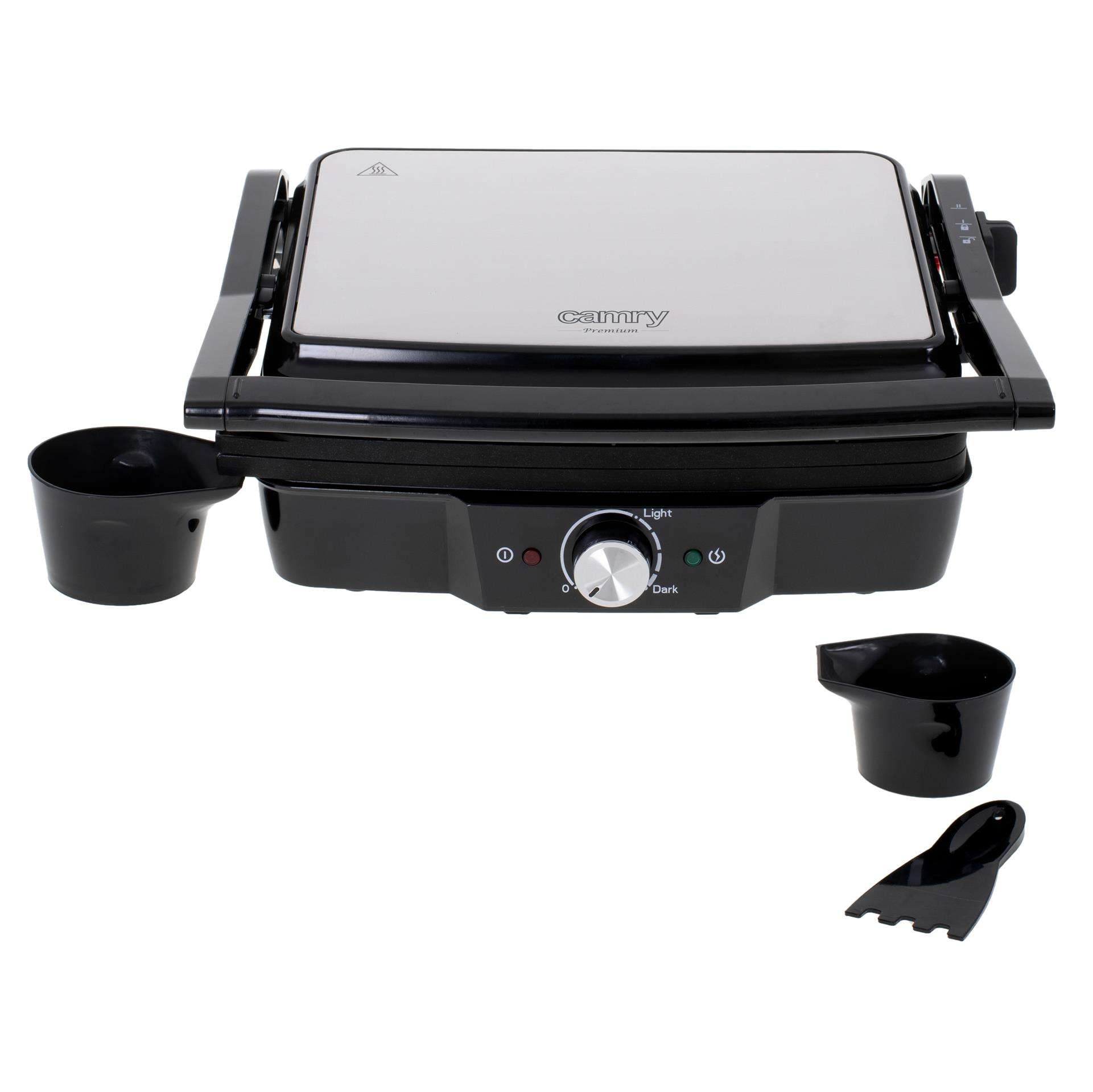 Czarny grill kontaktowy Camry ze srebrną pokrywą, pokrętłem temperatury, dwoma kubkami i szpatułką.