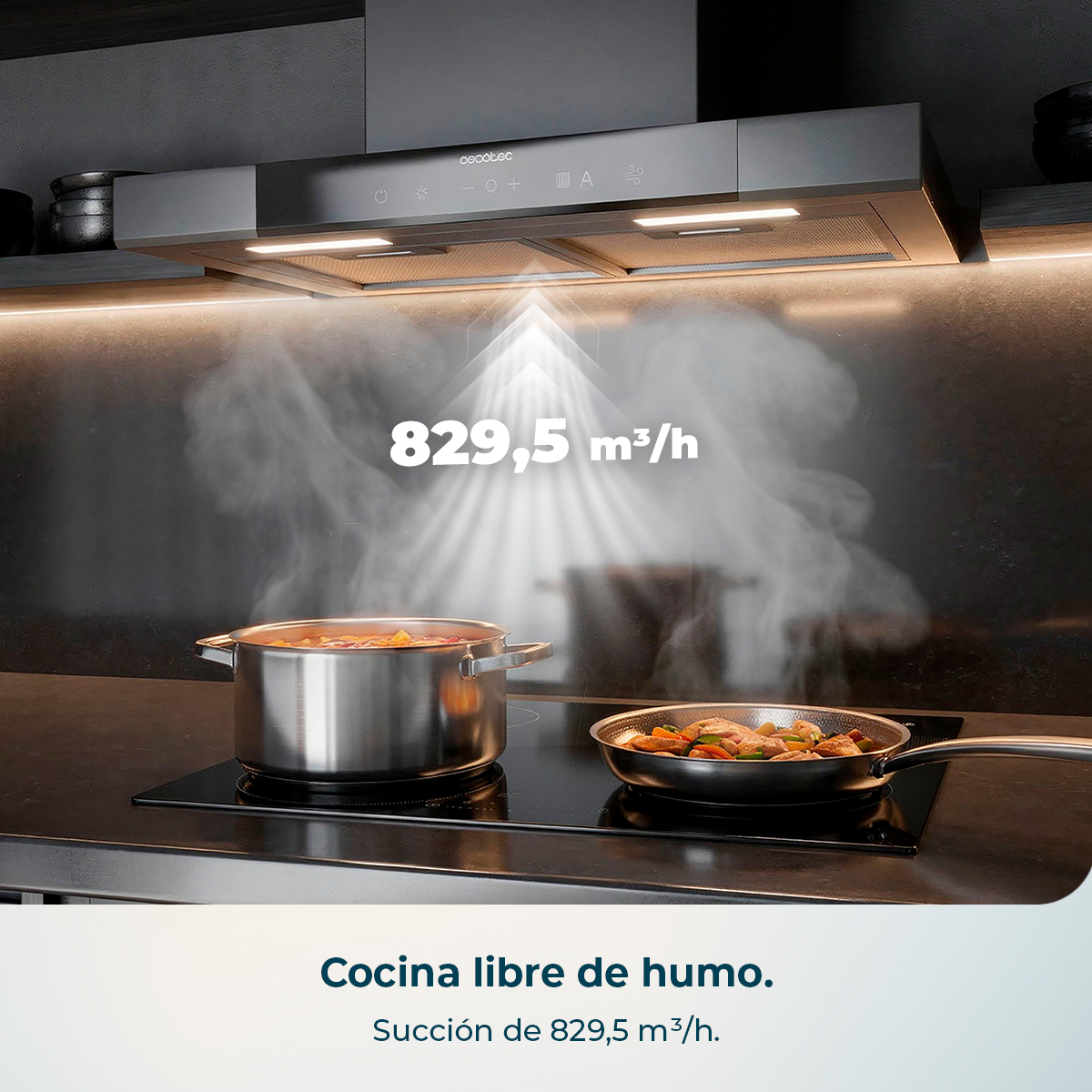 Campana extractora moderna sobre placa con olla y sartén, extrayendo humo.