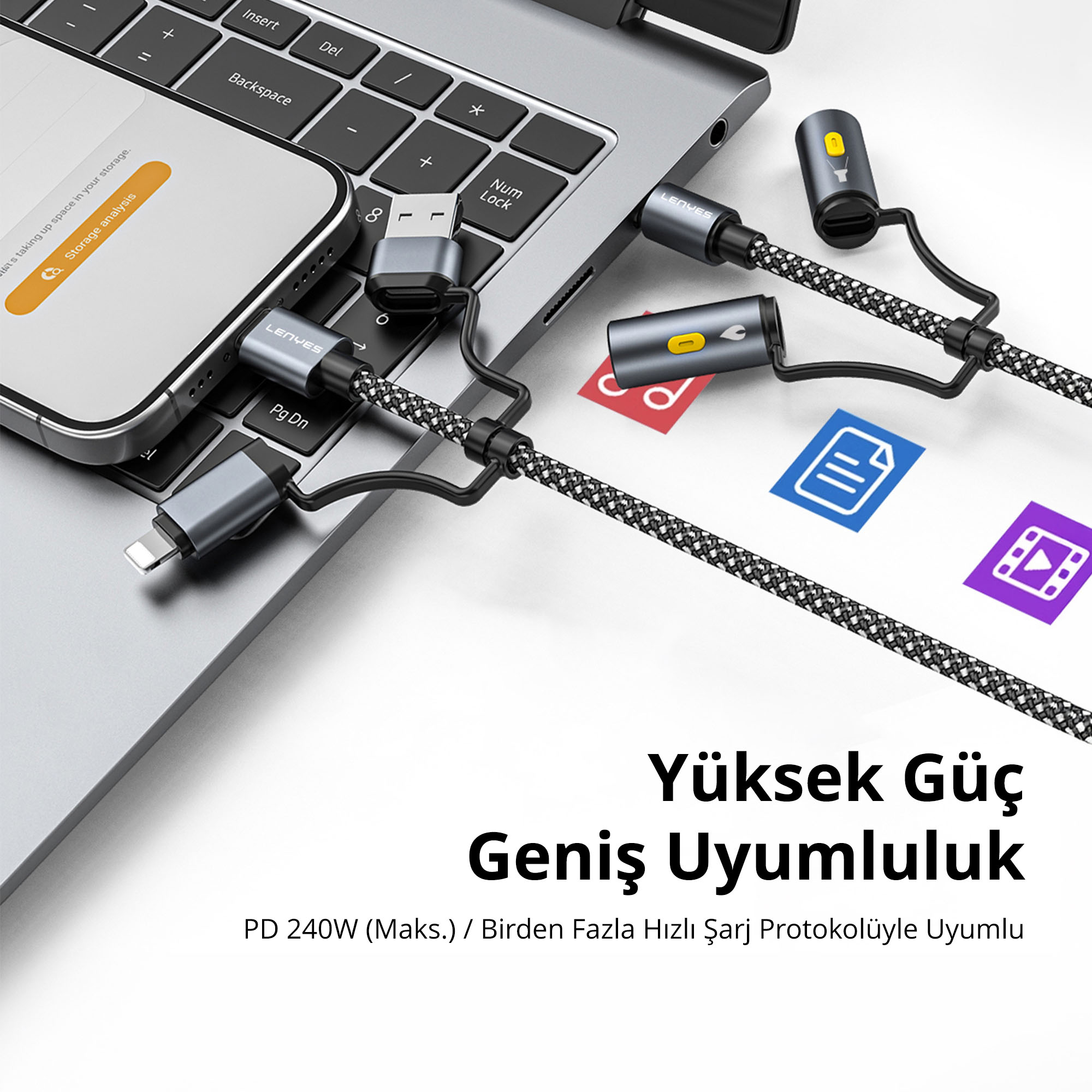 Dizüstü bilgisayar ve akıllı telefona bağlı, USB-C ve çeşitli adaptörlere sahip gri çoklu şarj kablosu.
