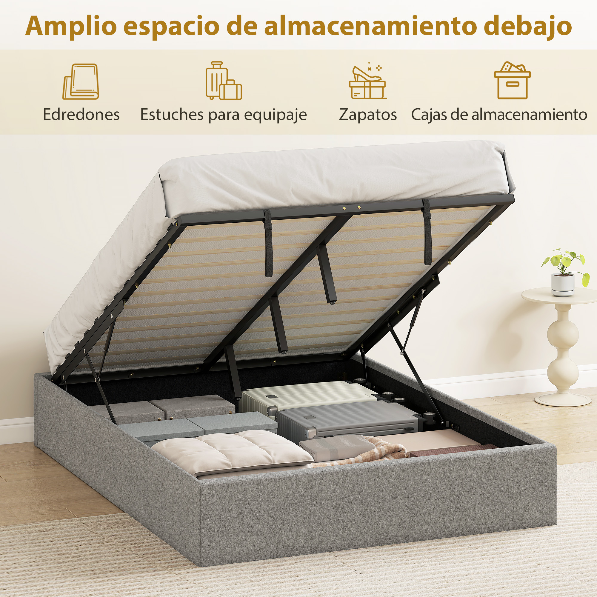 Cama gris con almacenamiento inferior abierto lleno de maletas y cojines.