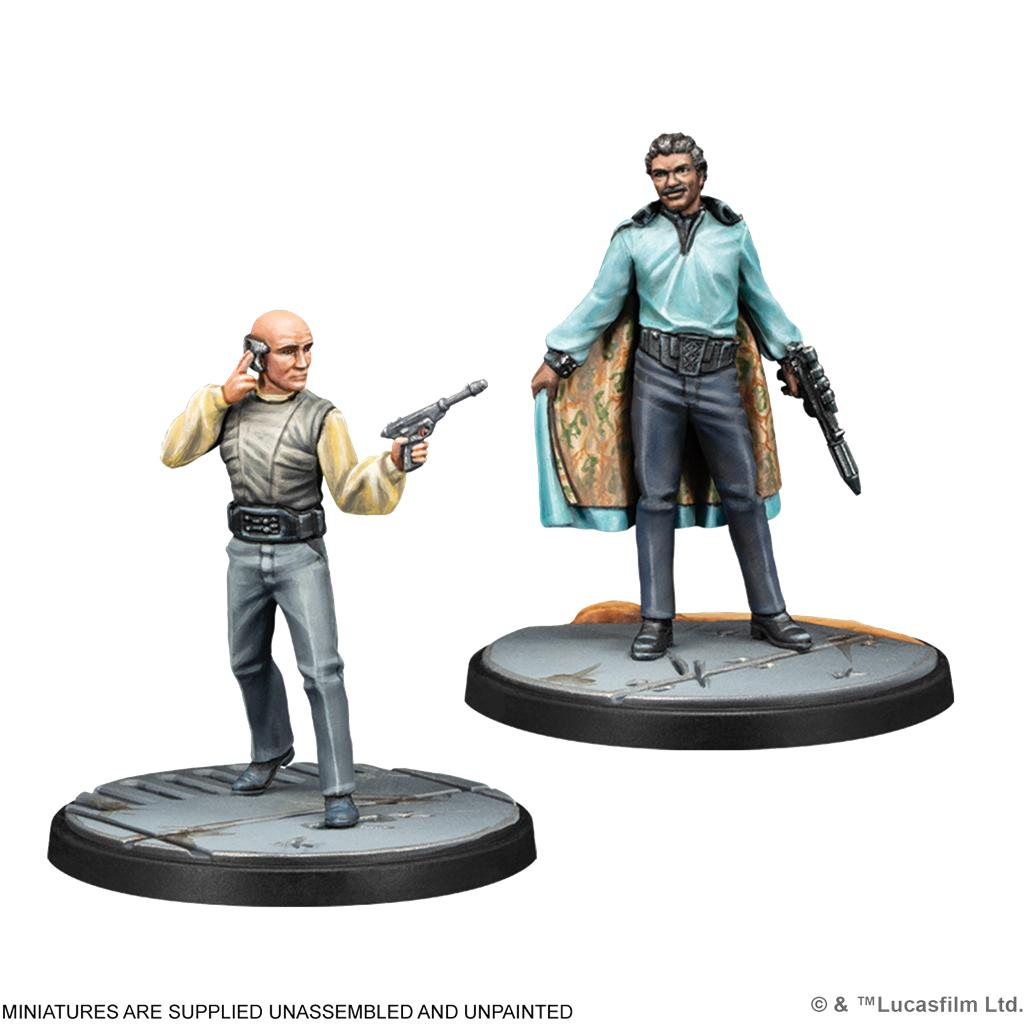 Dos miniaturas pintadas de personajes de Star Wars en bases redondas, uno sosteniendo un bláster.