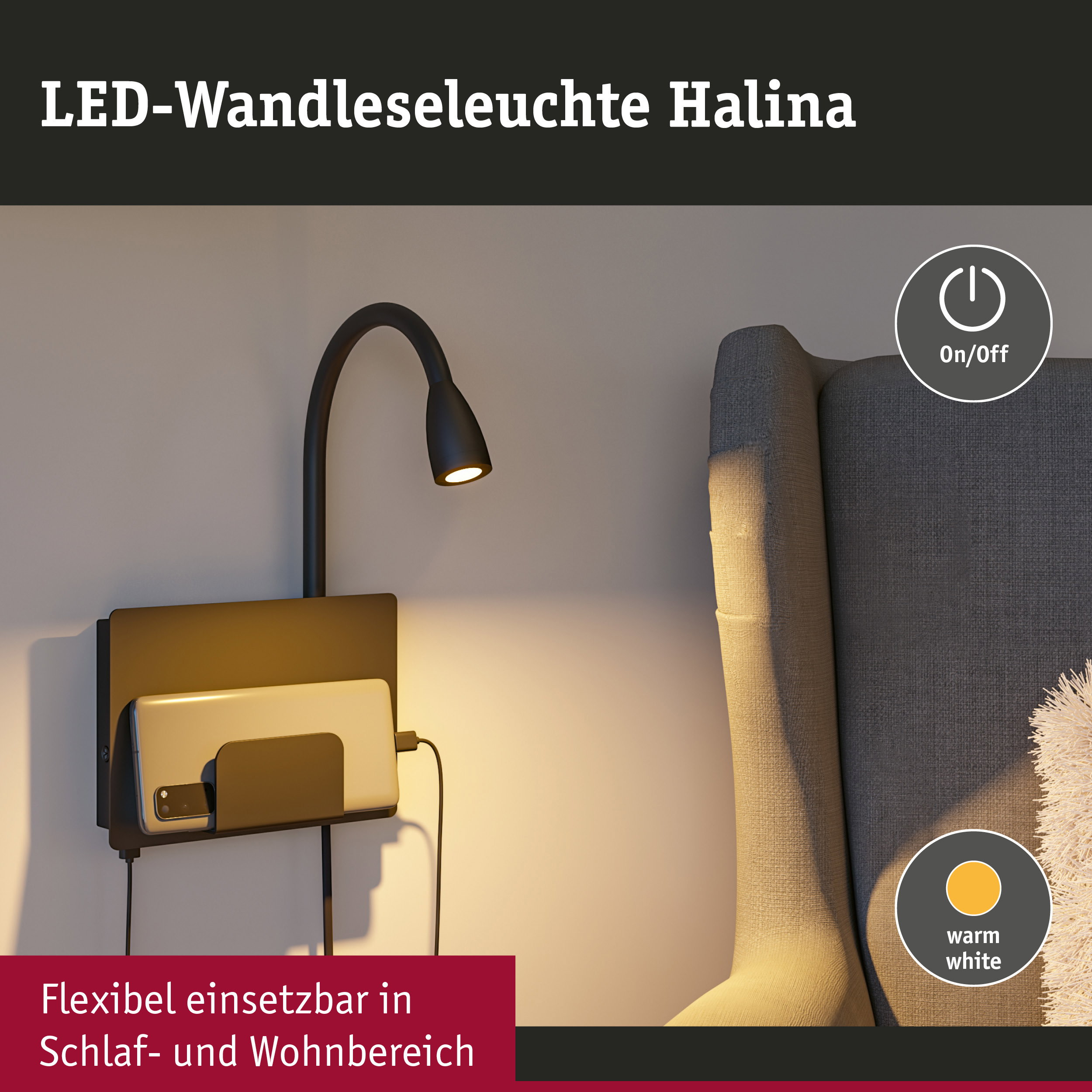 Schwarze LED-Wandleseleuchte mit Smartphone-Halterung und warmweißem Licht neben einem grauen Sessel.