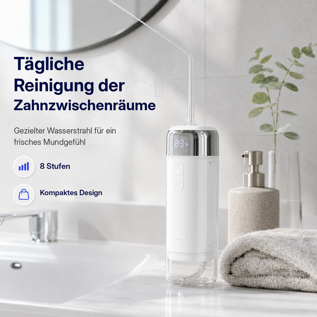 Eine weiße Munddusche auf einem Badezimmertisch mit Handtuch und Seifenspender.