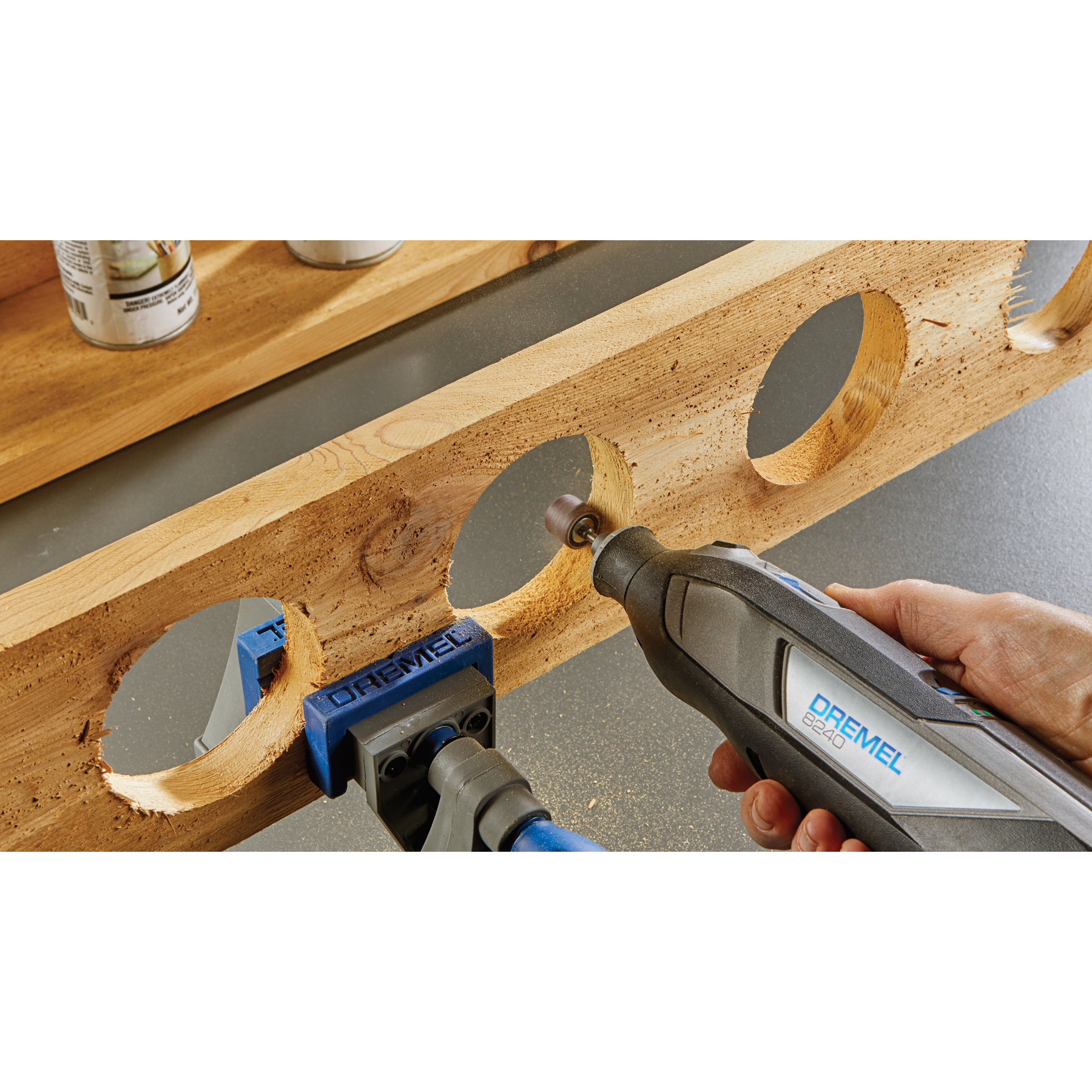 Eine Person schleift mit einem Dremel-Multifunktionswerkzeug das innere eines kreisrunden Lochs.