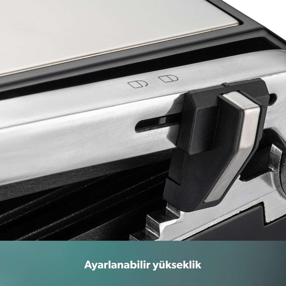 Siyah plastik yükseklik ayar kolu ve kilit simgeleri olan gümüş renkli bir tost makinesinin yakın planı.
