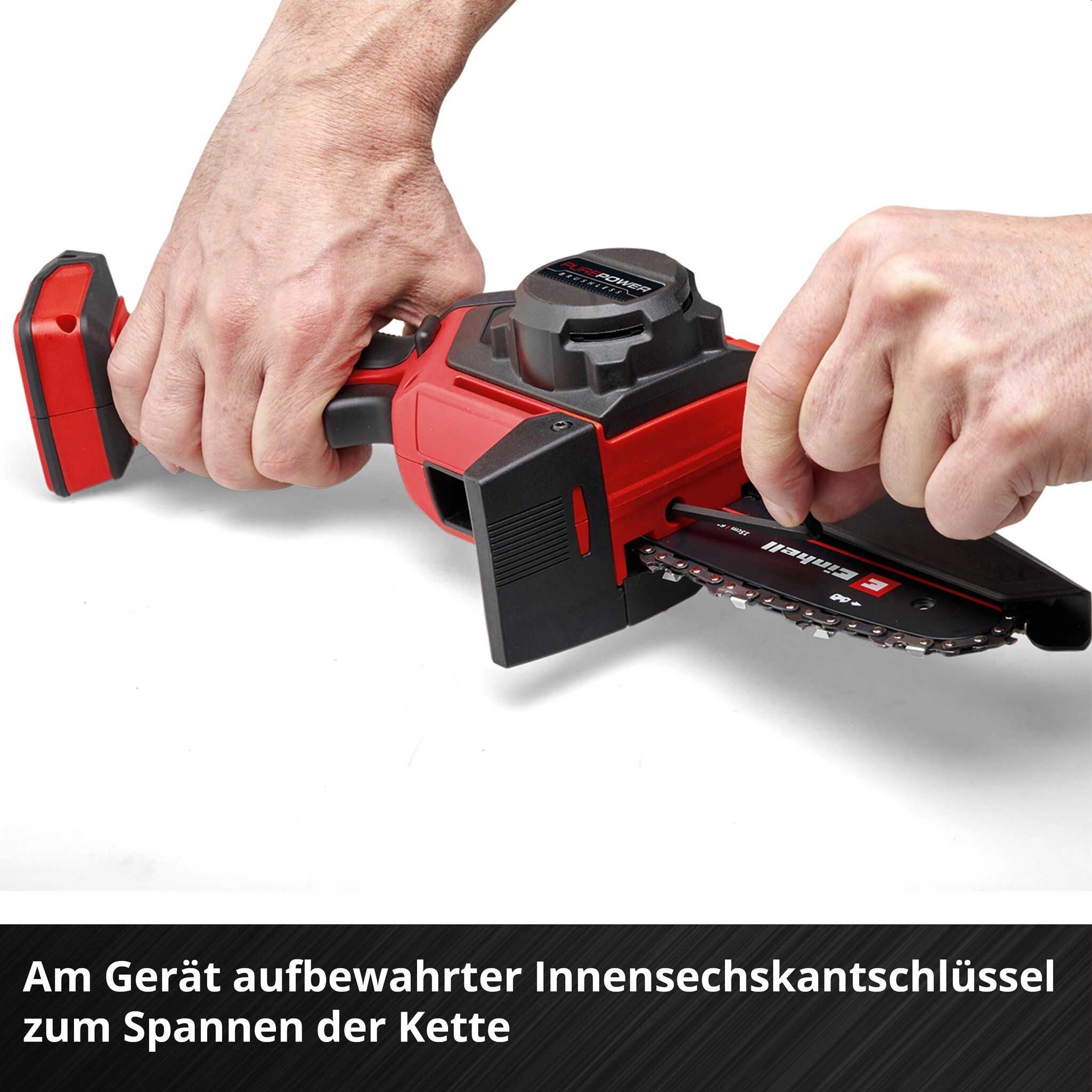 Hände spannen die Kette einer roten Minikettensäge mit einem Innensechskantschlüssel.