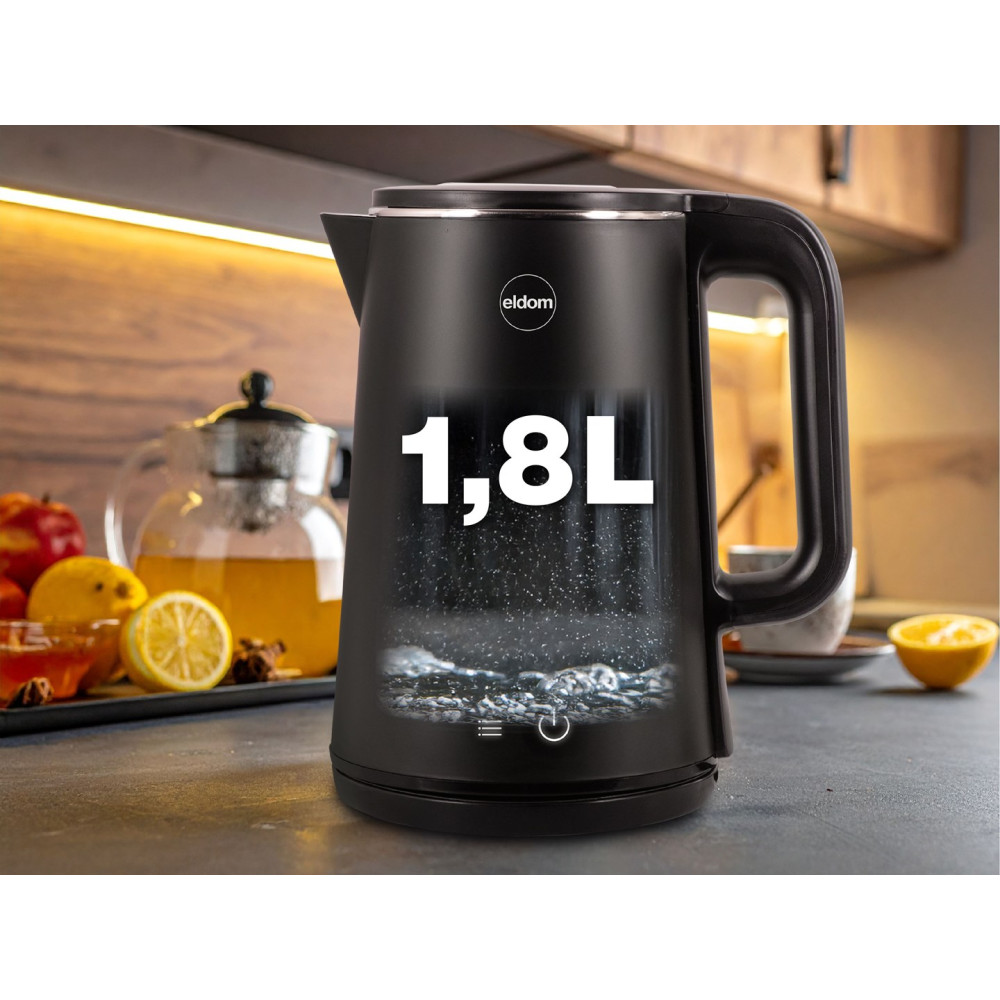 Czarny czajnik 1,8 l stoi na blacie kuchennym, a w tle widać cytryny i dzbanek do herbaty.