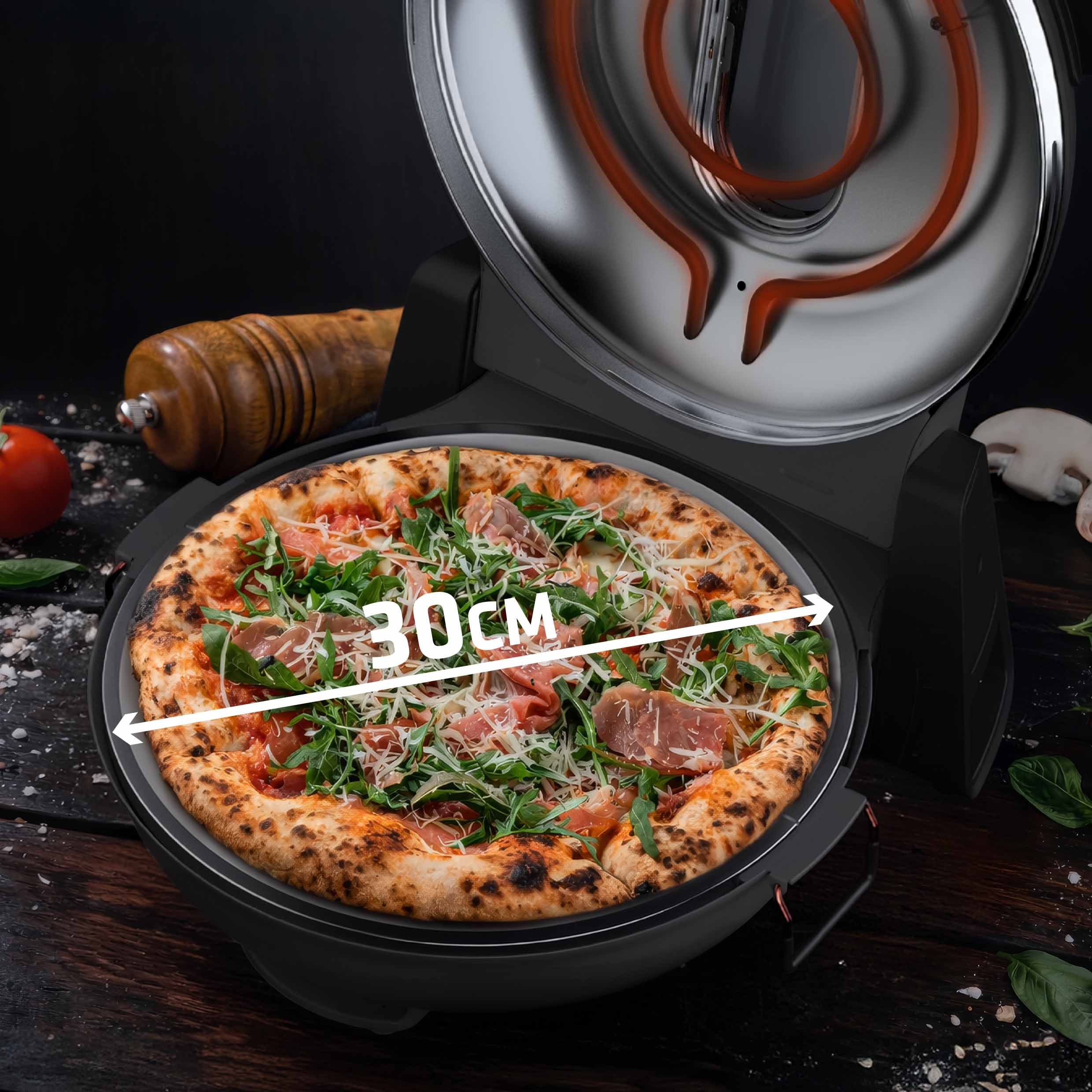 Otwarty piekarnik do pizzy na ciemnym drewnianym stole zawiera pizzę o średnicy 30 cm z zielenią, szynką i serem.