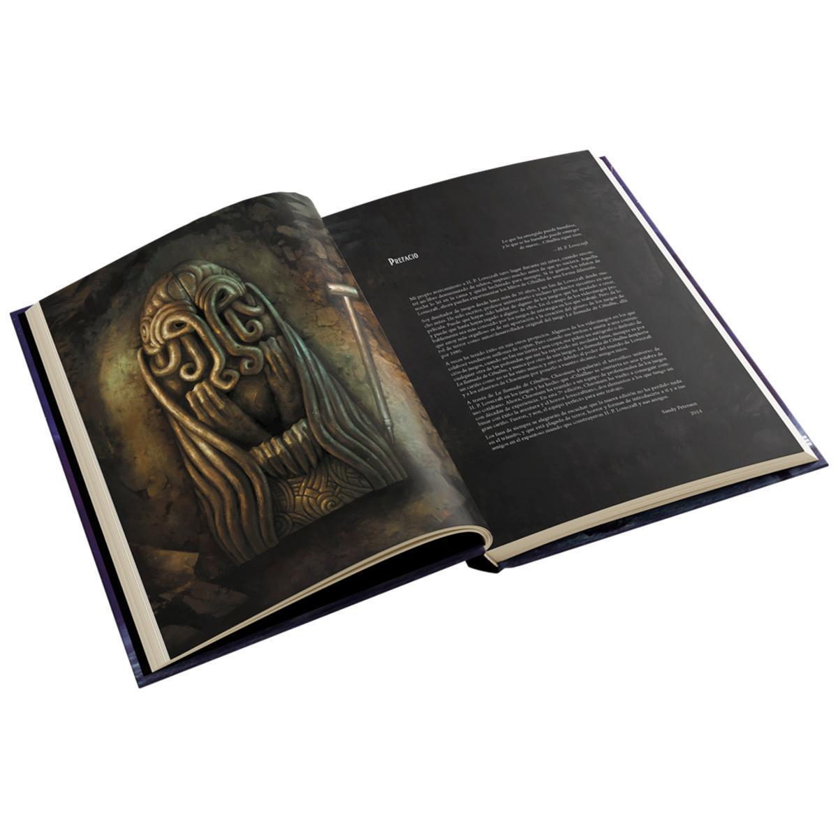 Un libro abierto muestra una escultura dorada en una página y texto en español con el encabezado Prefacio en la otra.