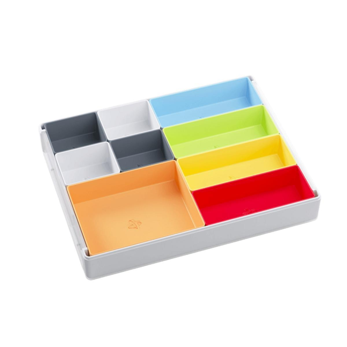 Una bandeja organizadora blanca con pequeños contenedores coloridos en azul, verde, amarillo, rojo, naranja, gris y blanco.