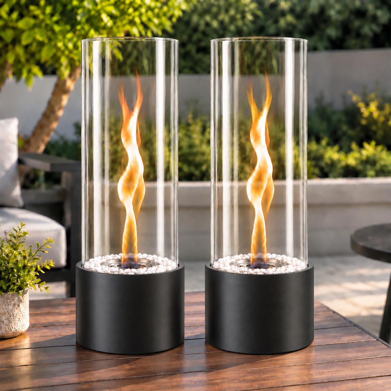 Zwei moderne Tischkamine mit Glaszylindern und tanzenden Flammen stehen auf einem Holztisch im Garten.