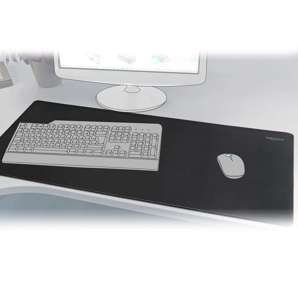 Schwarzes XXL-Mauspad mit aufgedruckter Tastatur und Maus auf einem weißen Schreibtisch vor einem Monitor.