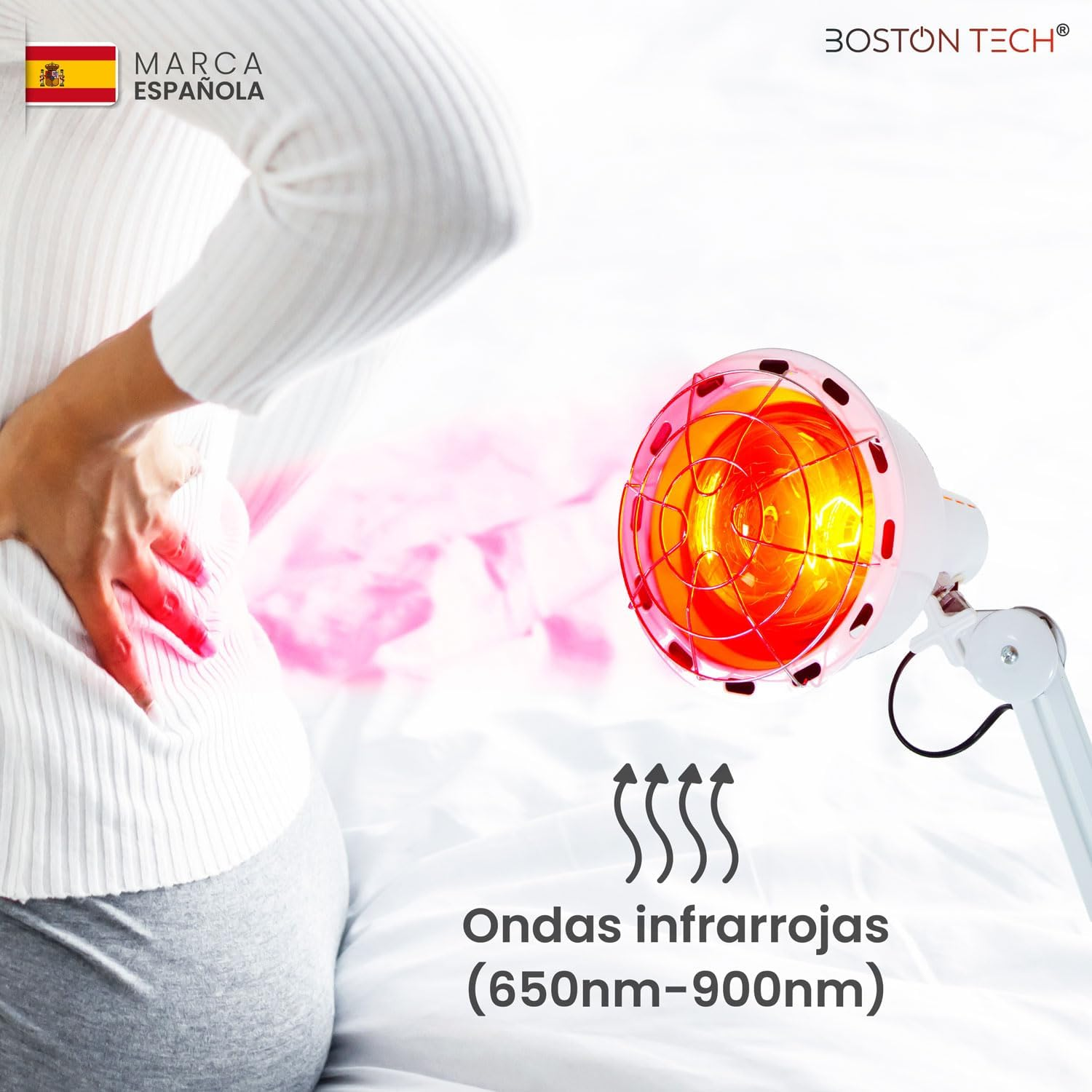 Una persona se sujeta la espalda adolorida mientras una lámpara infrarroja roja la ilumina.