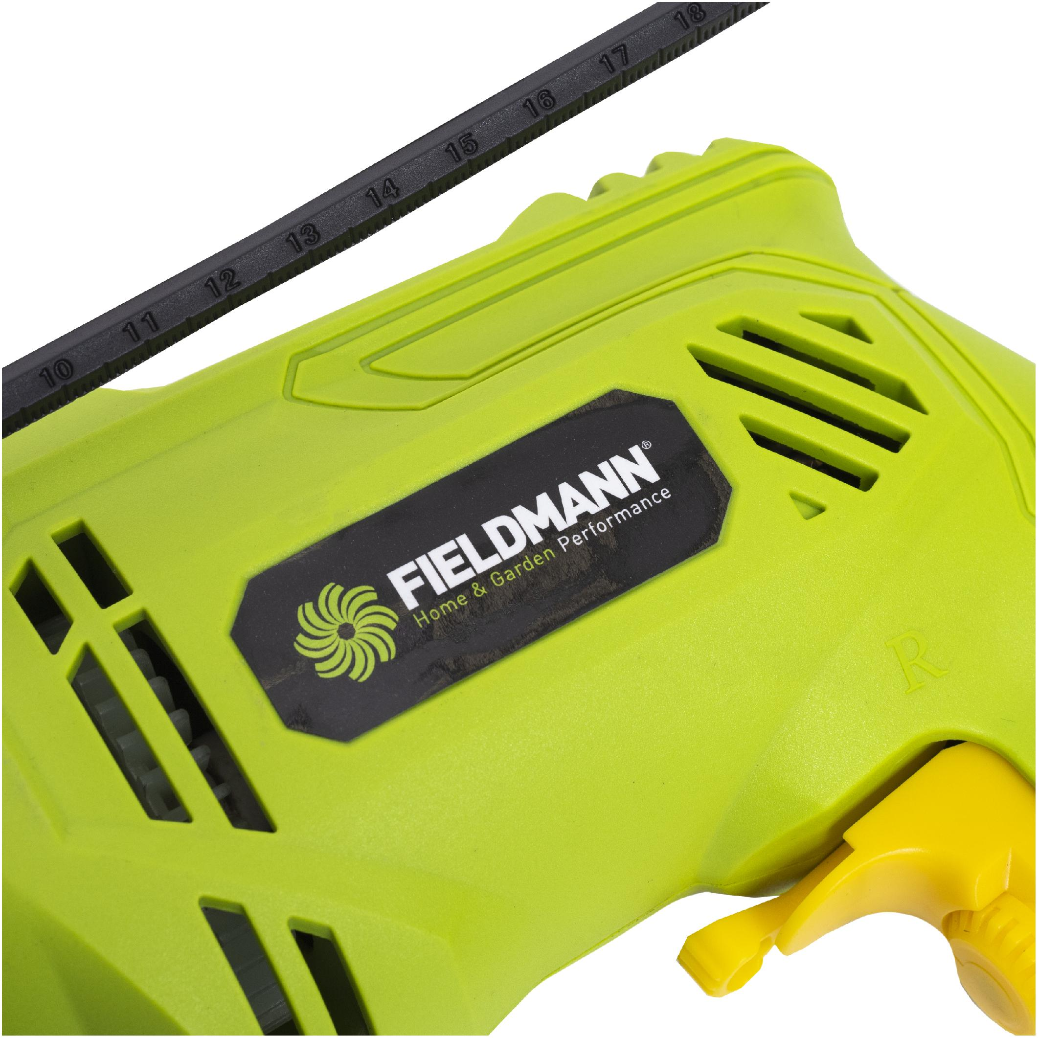 Trapano verde Fieldmann con logo nero e righello nero sopra.