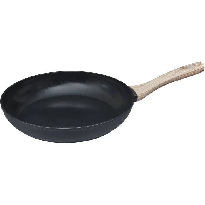 Schwarze Bratpfanne mit hellem Holzgriff vor weißem Hintergrund.