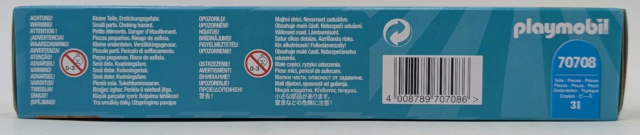 Lado de caja Playmobil azul con advertencias multilingües y código de barras.