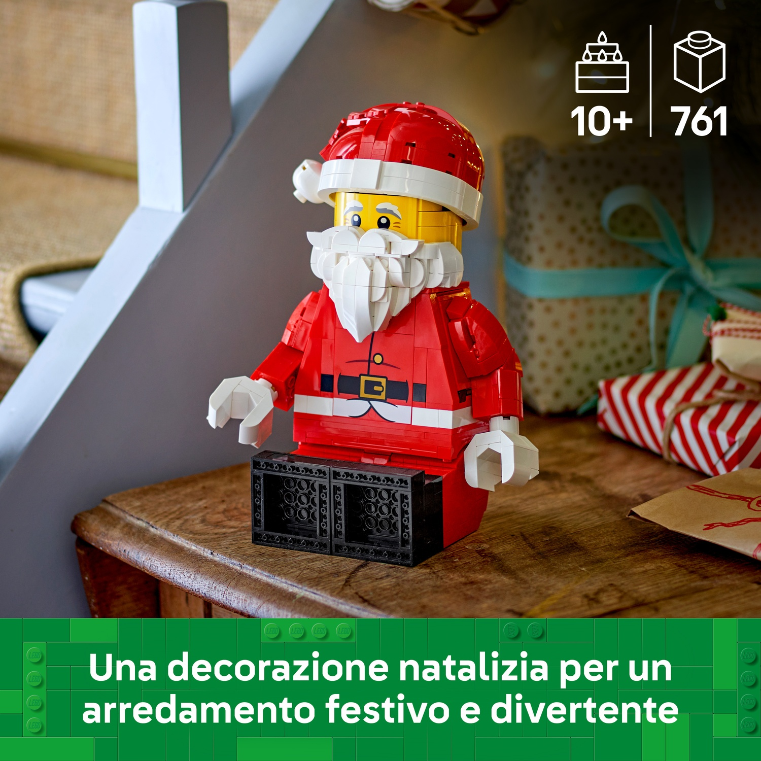 Figurka Świętego Mikołaja z klocków Lego na drewnianym stole z prezentami w tle.