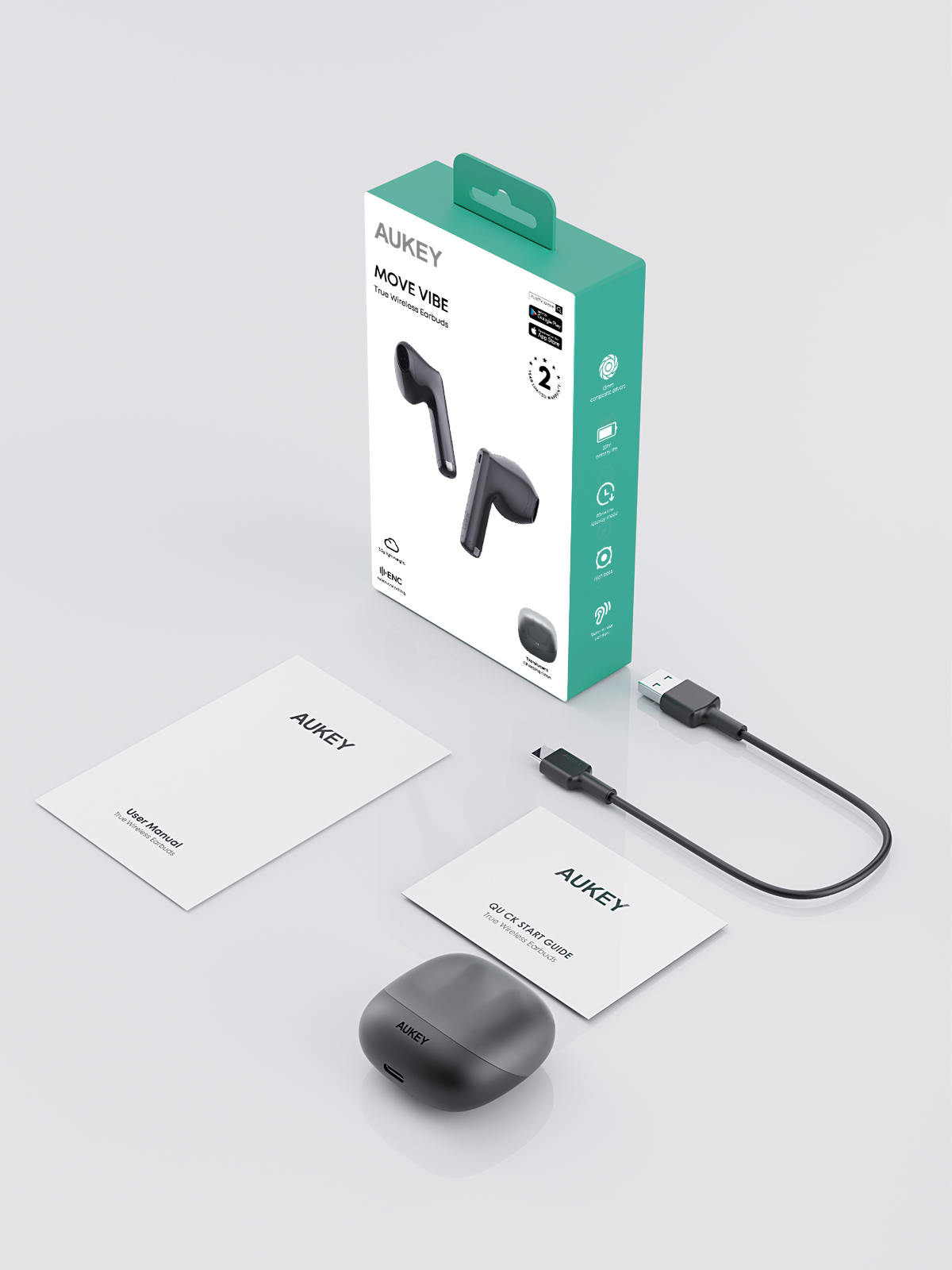 Beyaz zemin üzerinde şarj kutusu, USB kablo ve kılavuzlarla birlikte kutusunda Aukey Move Vibe kulaklık.
