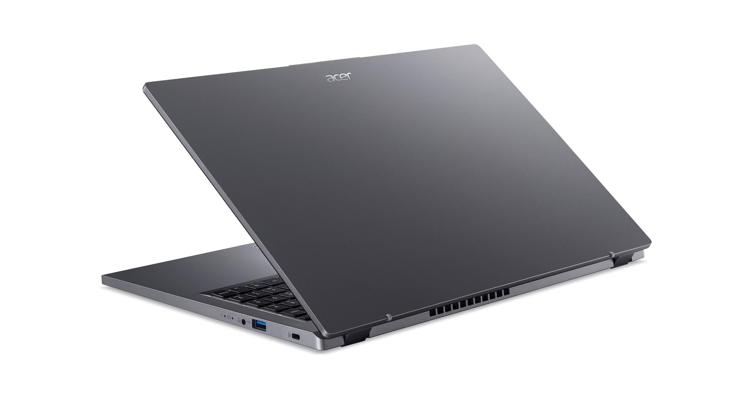 Kapağı açık gri renkli bir Acer dizüstü bilgisayar, beyaz bir yüzey üzerinde.