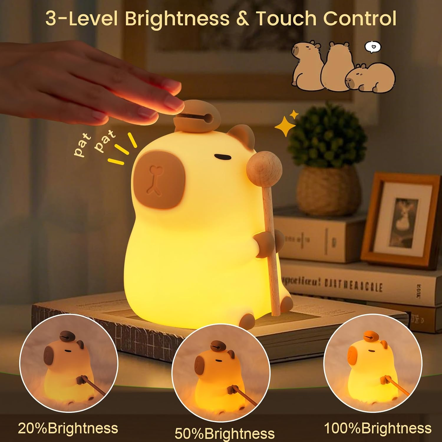 Eine leuchtende Capybara-Lampe mit Touch-Steuerung auf Büchern zeigt drei Helligkeitsstufen.
