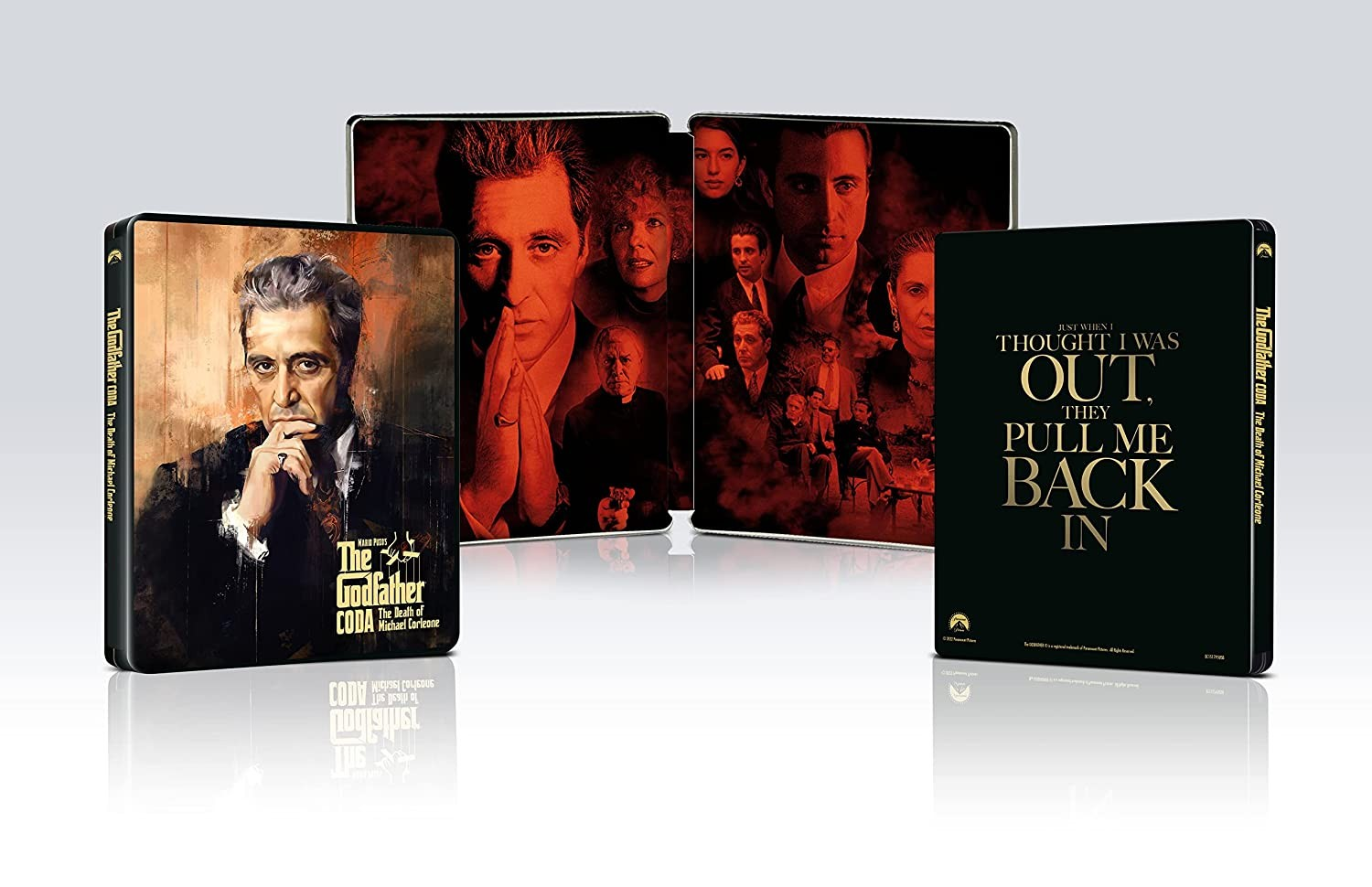 Edición steelbook de El Padrino Coda con retratos de personajes en rojo y negro y famosa frase.