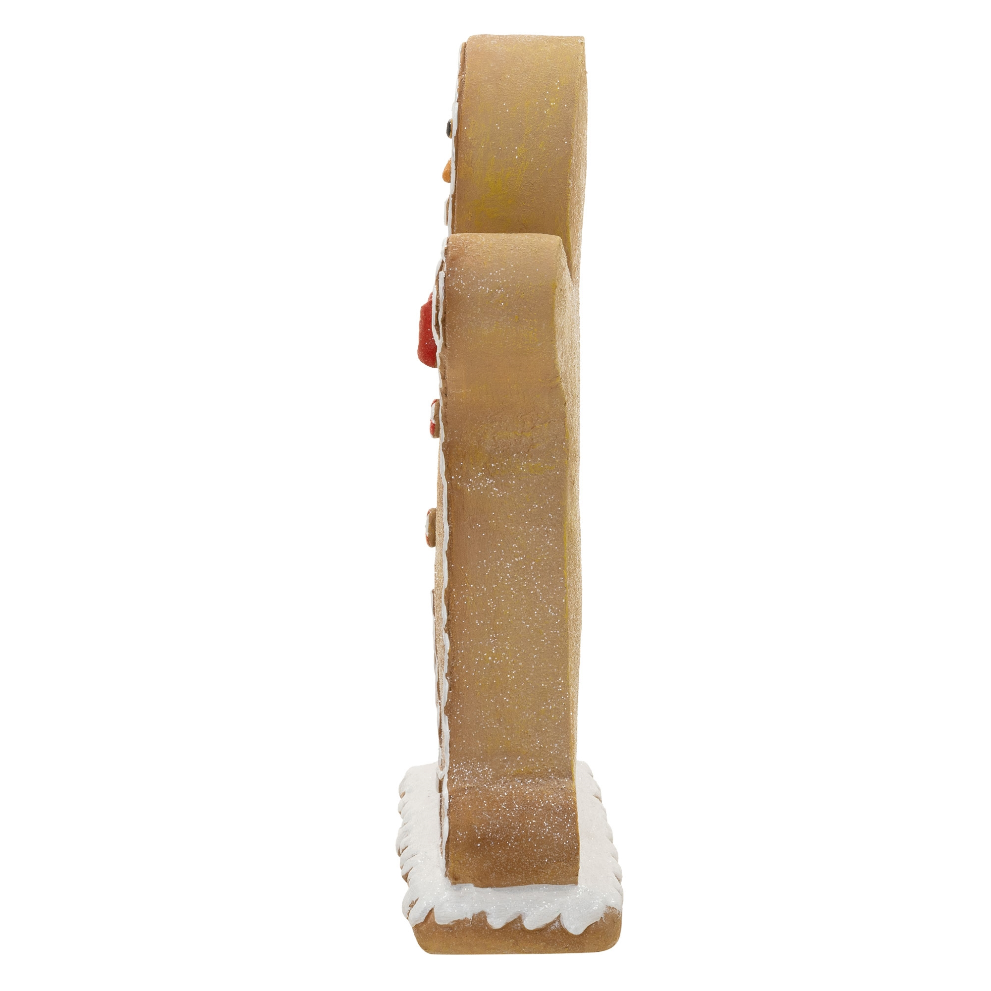 Seitenansicht einer stehenden Lebkuchenfigur auf weißem Sockel mit weißem Icing.