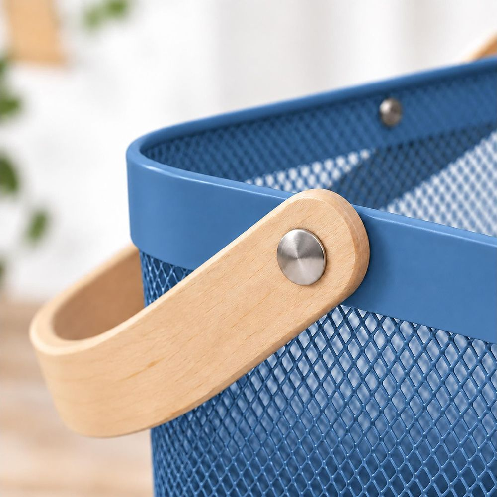 Close-up of a blue metal mesh basket with a wooden handle and metal rivet.