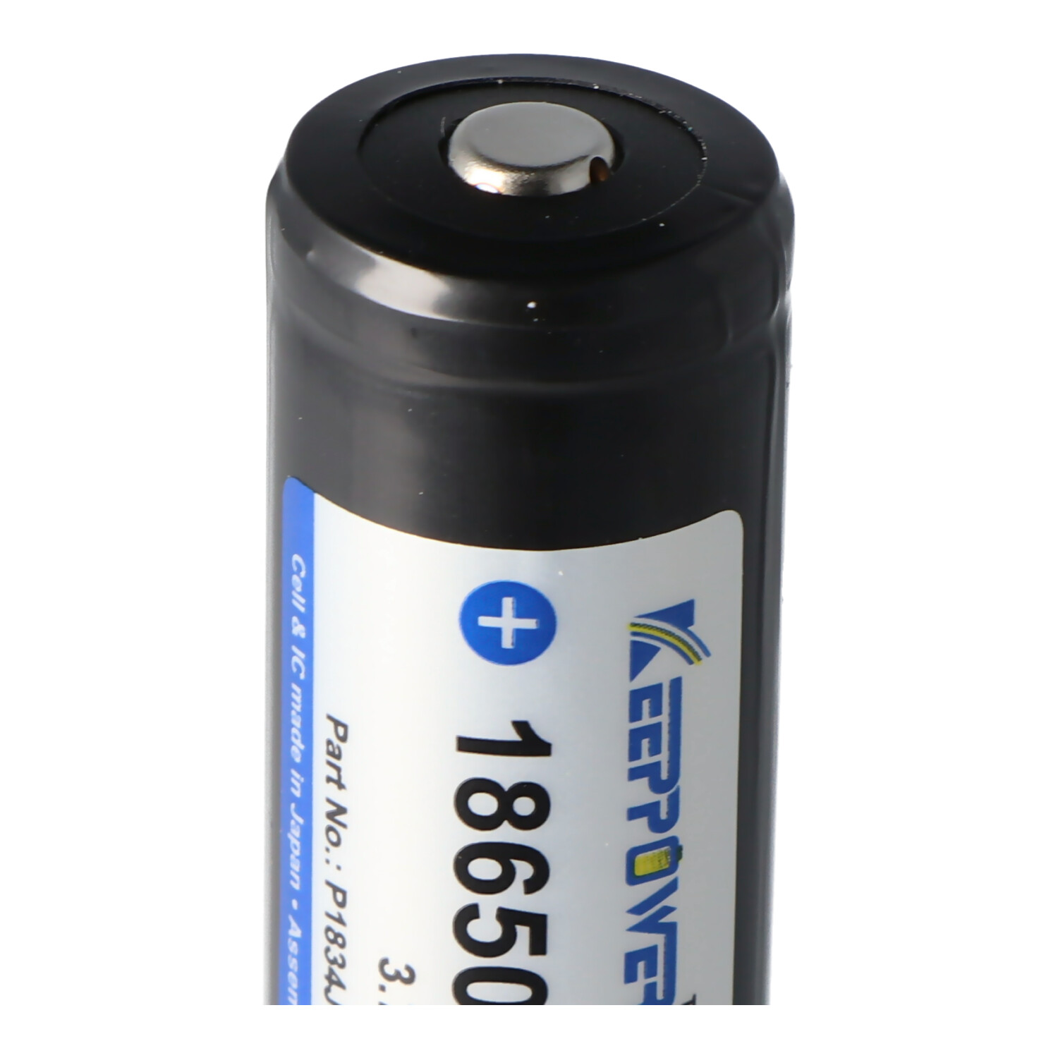 Close-up of a black cylindrical battery labeled with text and a plus sign on a white background.