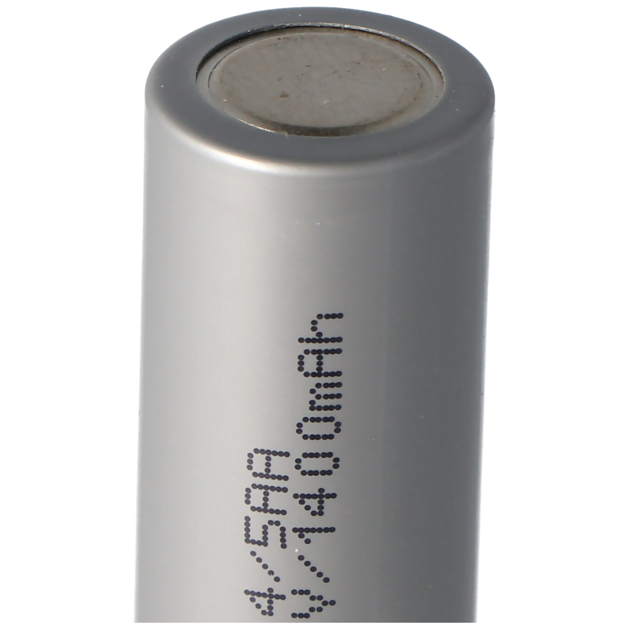 A close-up of a silver battery with text on it against a white background.