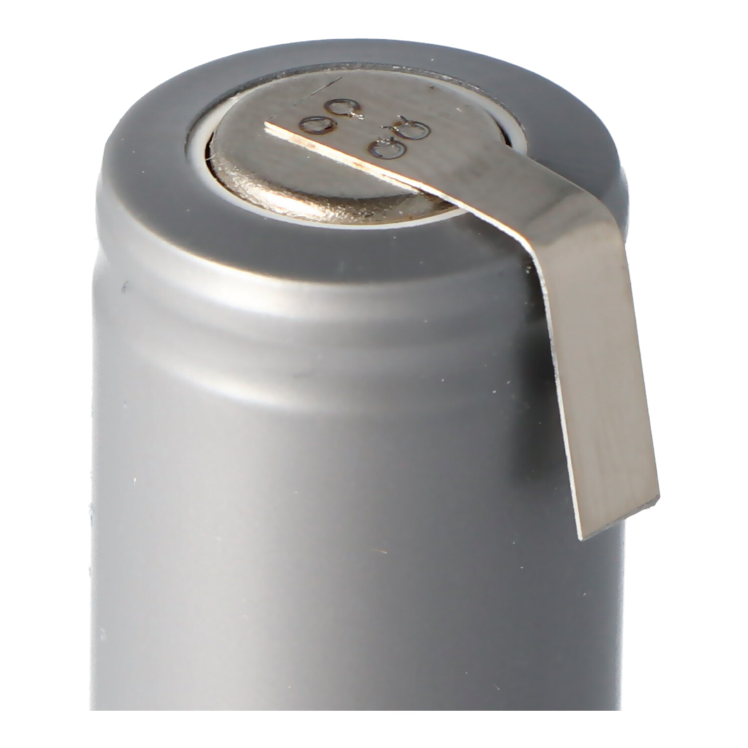 Gray cylindrical battery with a silver metal contact, isolated on white.