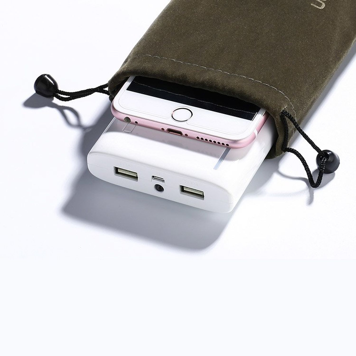 Telefono bianco in custodia verde. Telefono su power bank bianco. Coulisse nera.