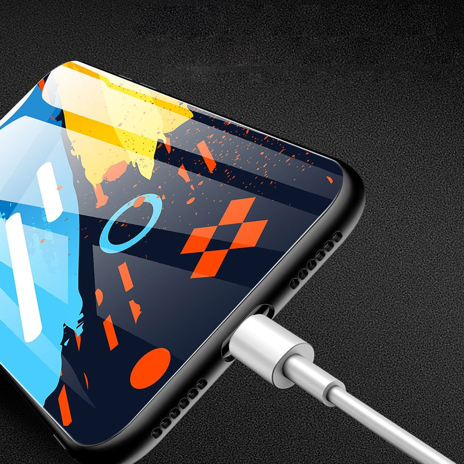 Telefon mit farbenfrohem Design, Aufladen mit silbernem Kabel auf schwarzer Oberfläche.