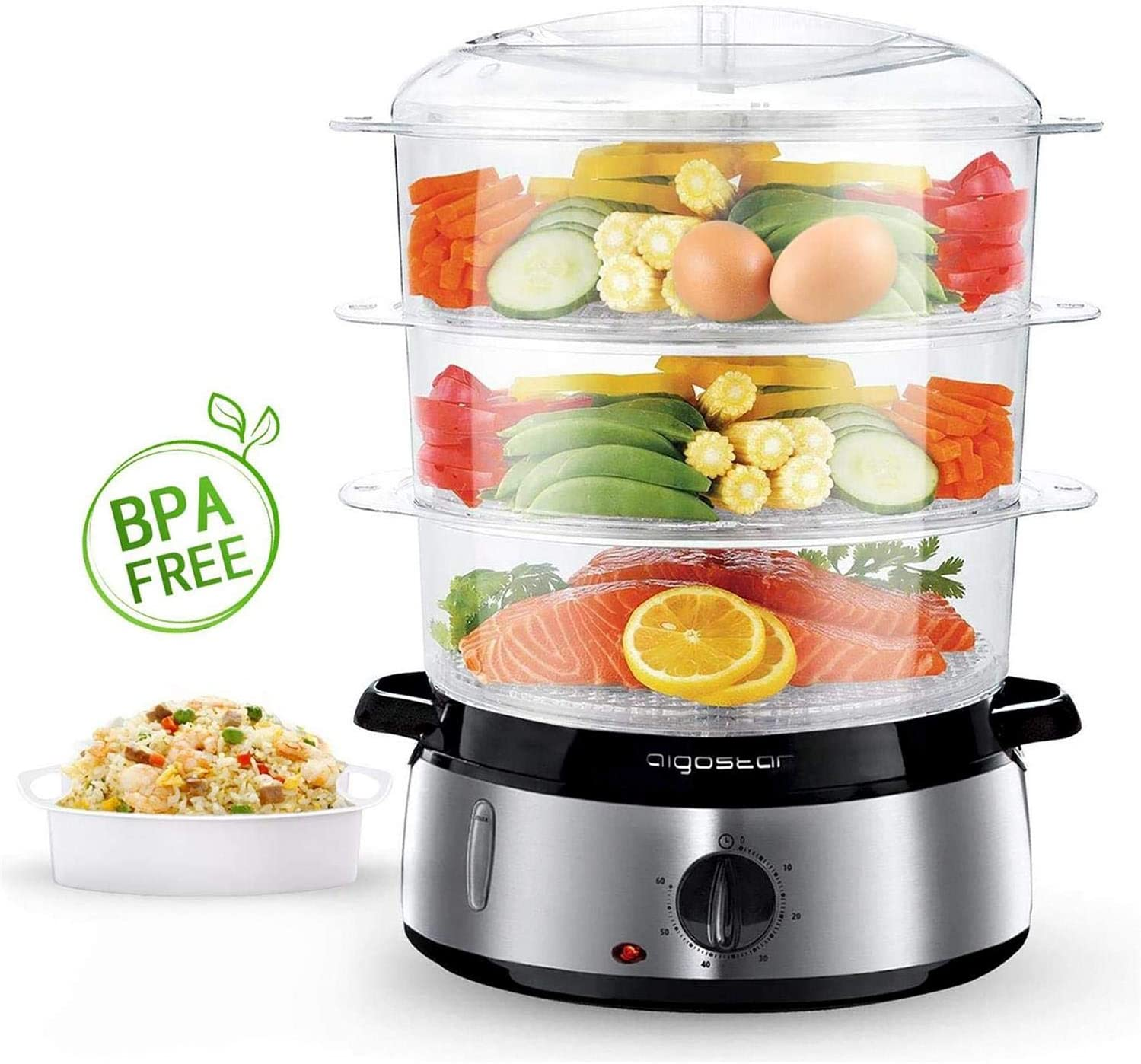 Un vaporizzatore a tre livelli con verdure, uova e salmone. Una ciotola di riso a sinistra.