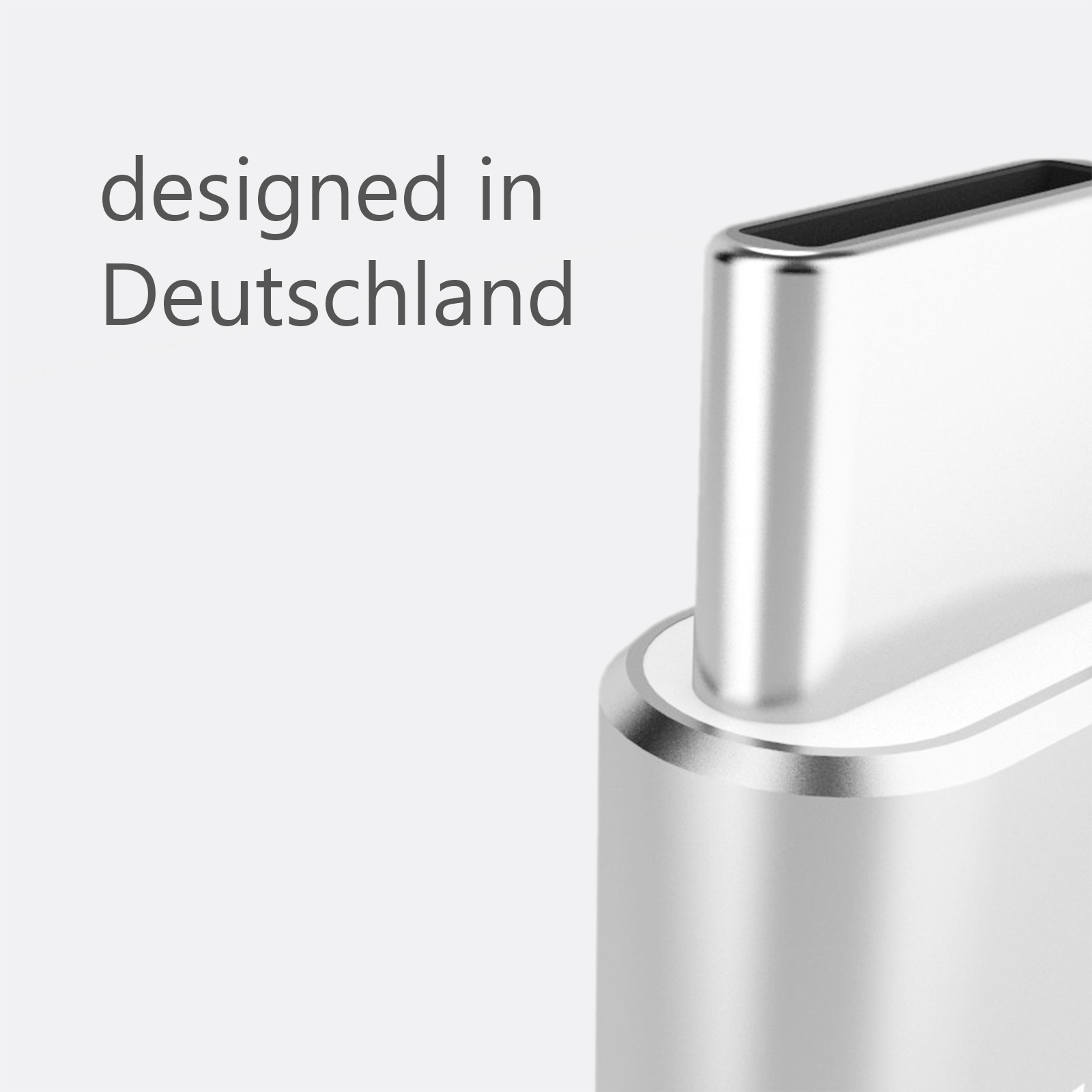 Nahaufnahme eines silbernen USB-C-Anschlusses mit dem Text 'designed in Deutschland'.