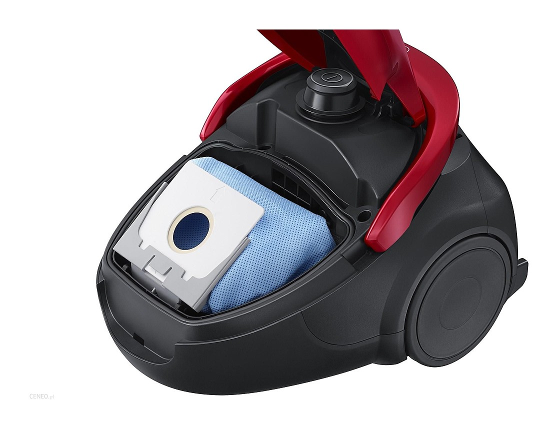 Odkurzacz z otwartą komorą. Niebieski worek filtracyjny jest widoczny wewnątrz komory.