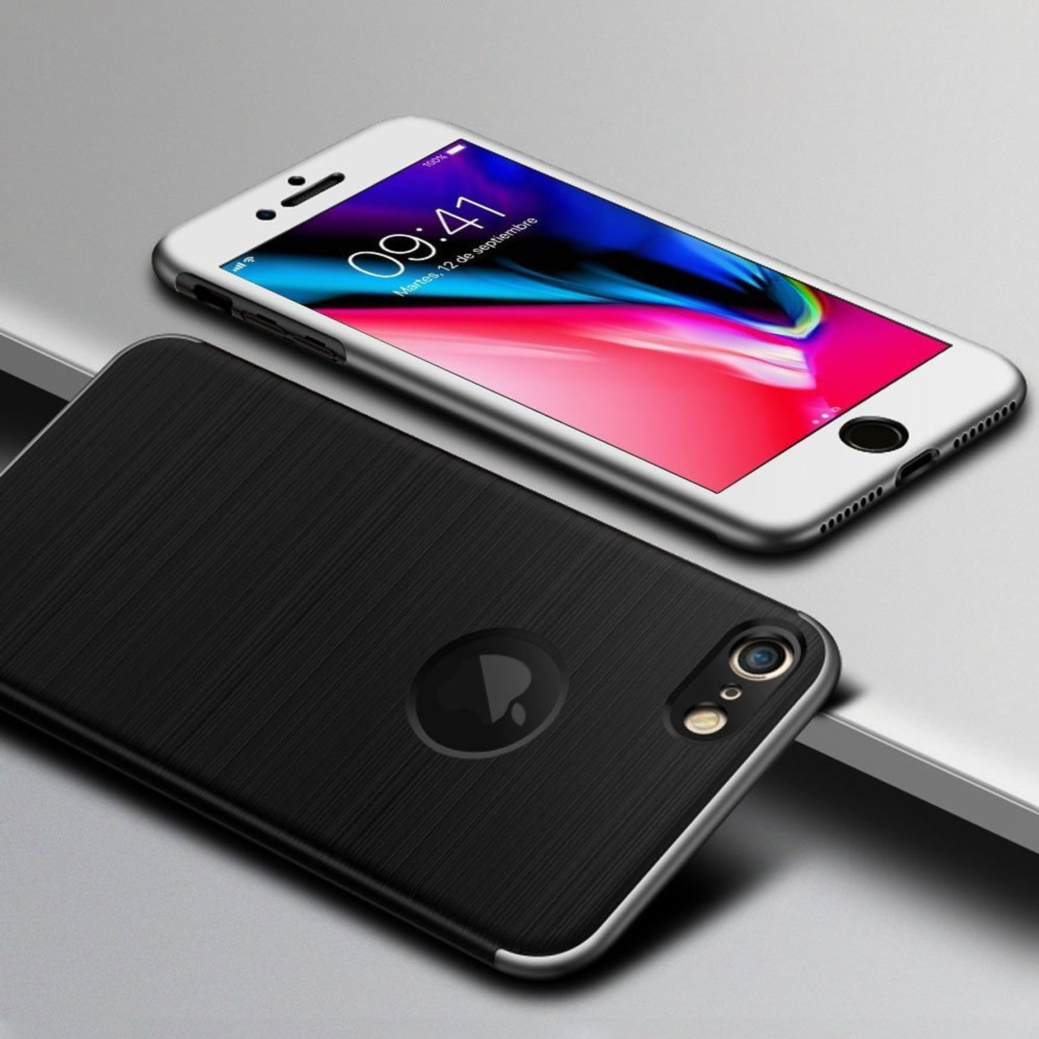 Zwei Telefone, eines silber, eines schwarz. Die schwarze Handyhülle ist strukturiert. Beide Telefone liegen auf einer reflektierenden Oberfläche.