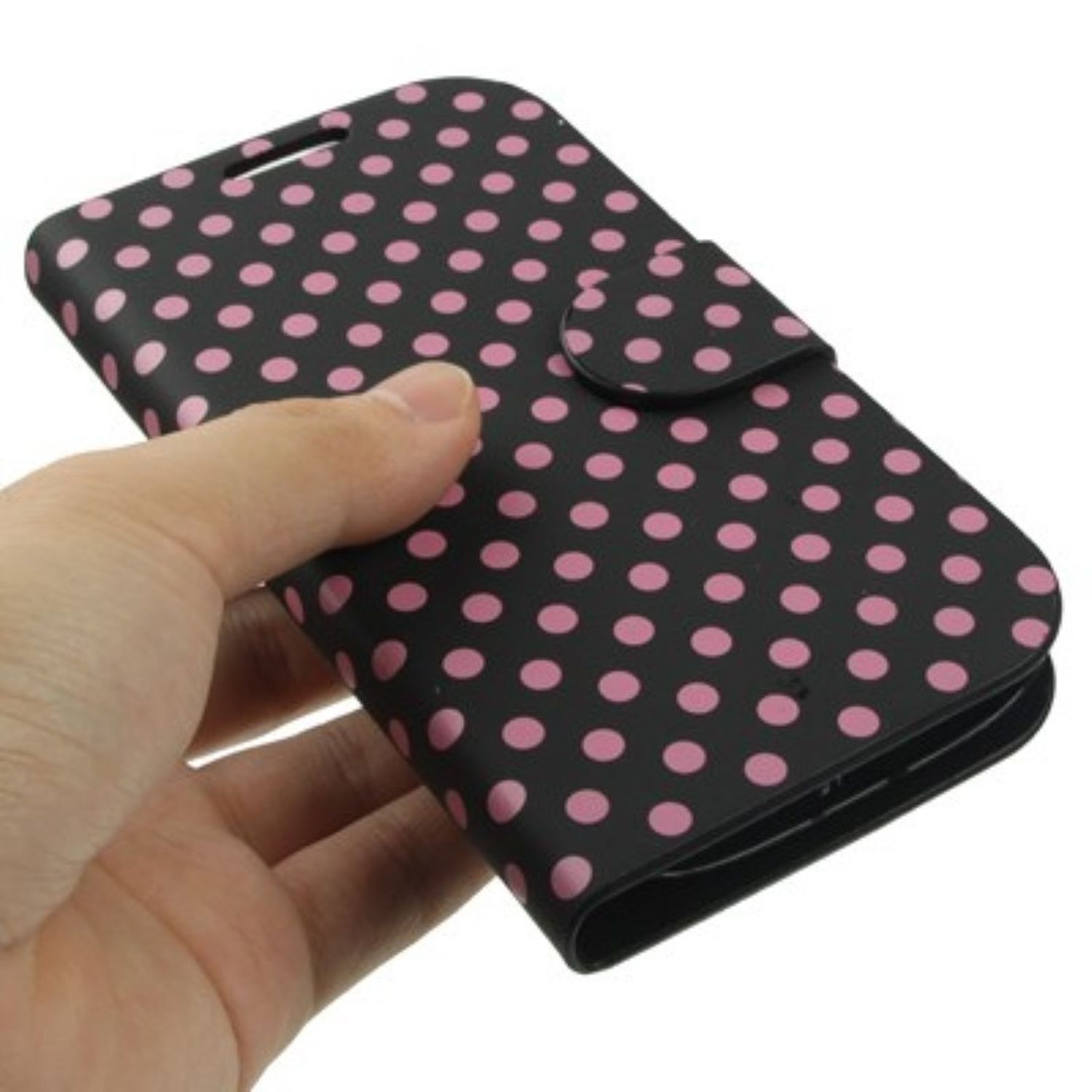 Eine Hand hält eine schwarze Handyhülle mit rosa Tupfen. Die Hülle ist geschlossen.