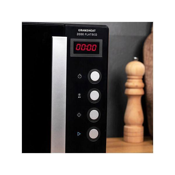 Panel sterowania kuchenki mikrofalowej z wyświetlaczem cyfrowym, przyciskami i solniczką.