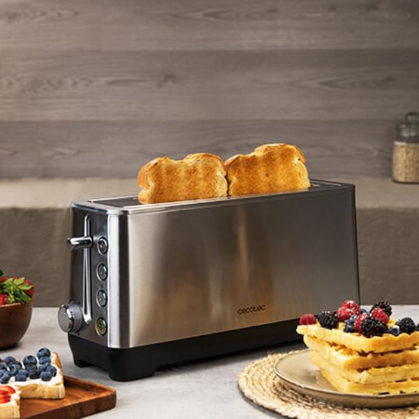 Toster z dwoma kromkami tostów i talerzem gofrów z jagodami na drewnianym stole.