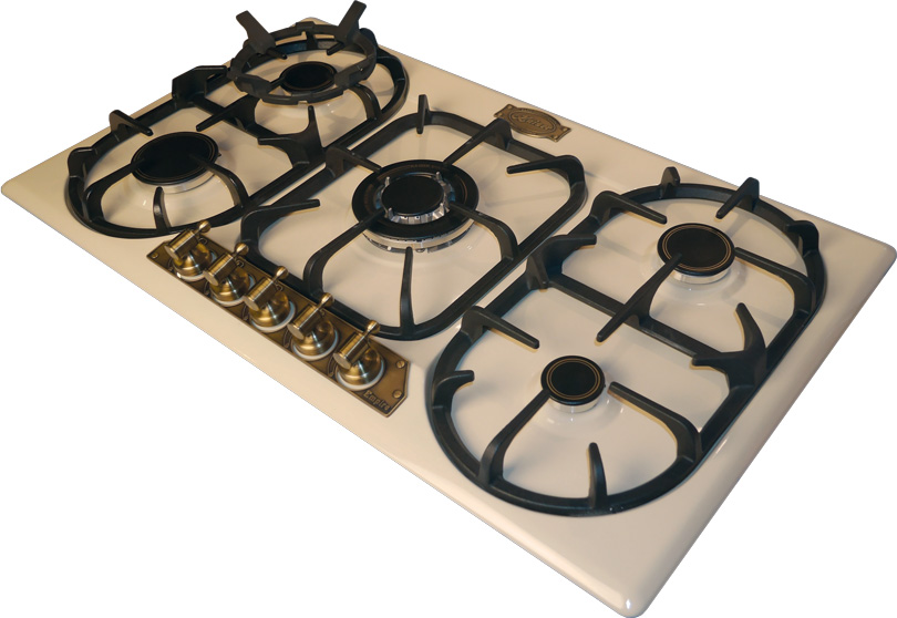 Una cocina de gas blanca con cuatro quemadores y perillas de latón. Tiene rejillas negras.