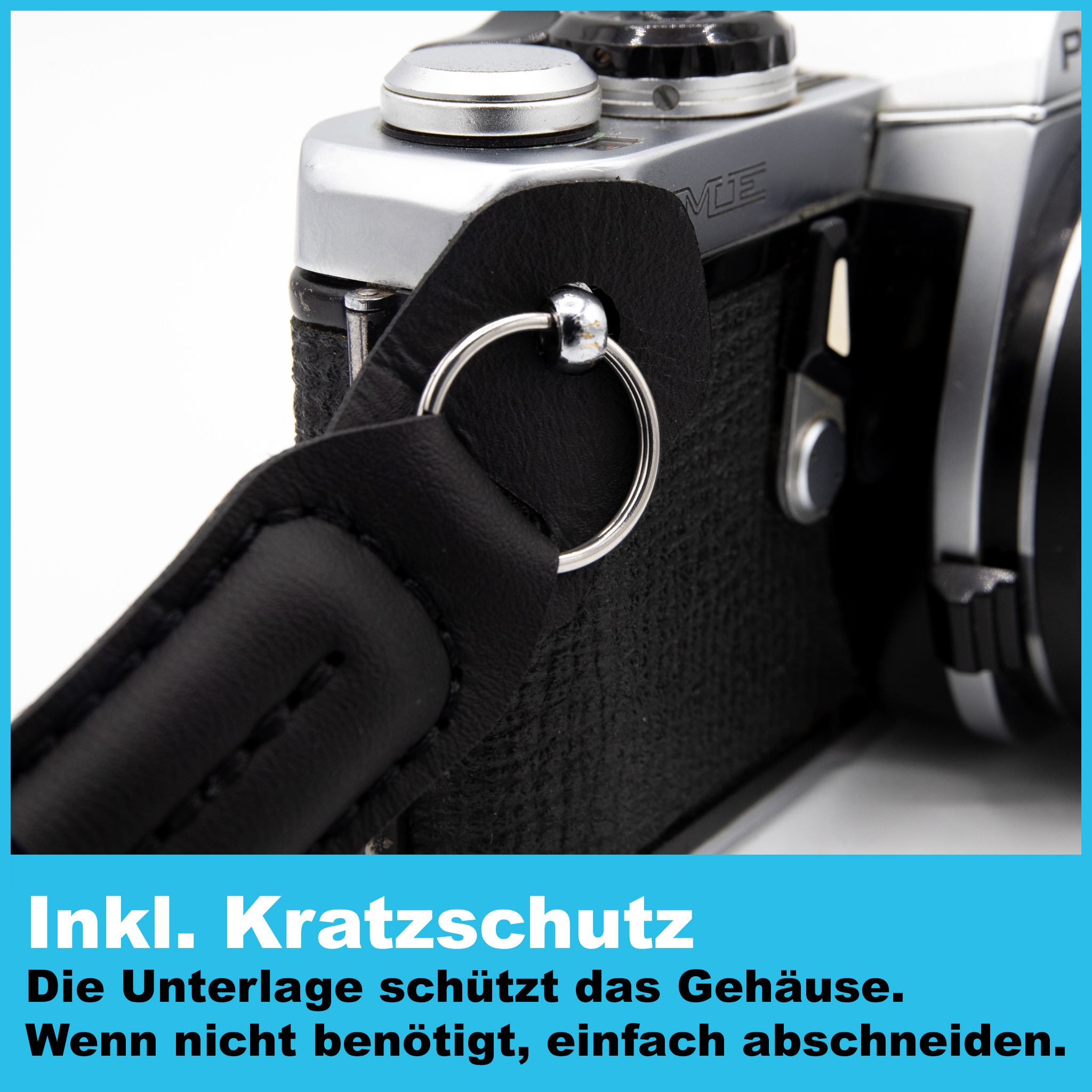 Nahaufnahme eines Kameragurts an einem Kameragehäuse. Die Kamera ist silber und schwarz.