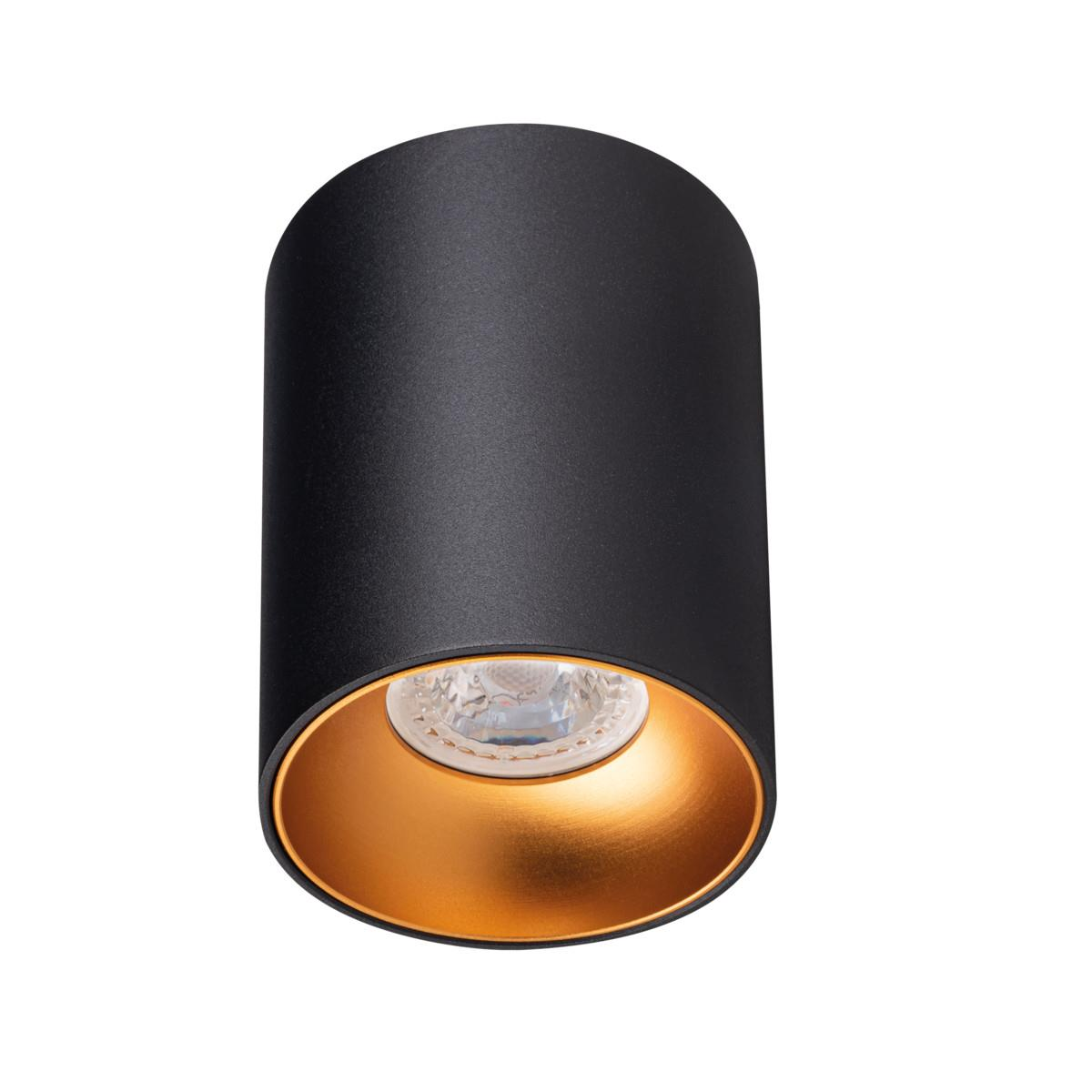 Apparecchio di illuminazione cilindrico nero con interno dorato.